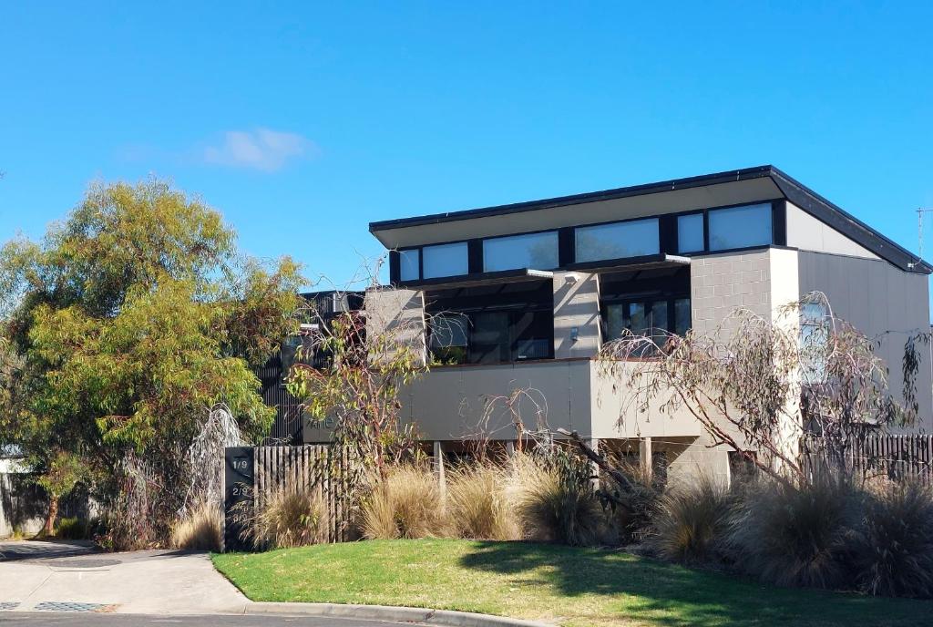 a house with black windows on the side of it at Luxe Townhouse - WiFi included in Inverloch