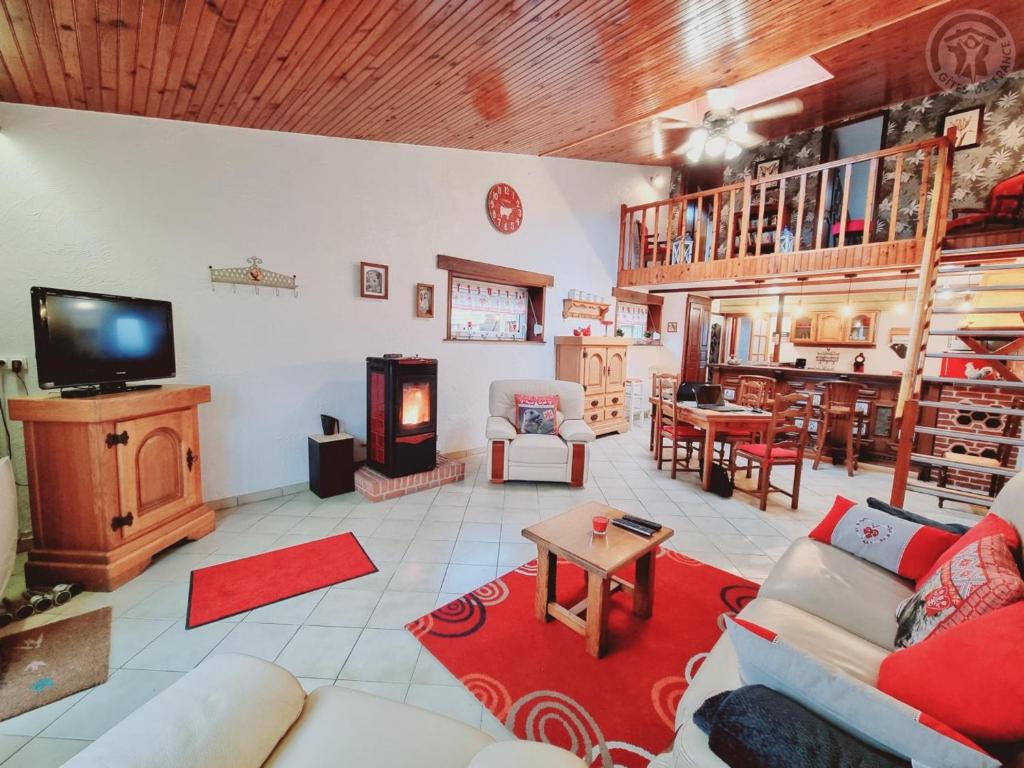 a living room with a couch and a fireplace at Gîte Eppe-Sauvage, 4 pièces, 4 personnes - FR-1-510-183 in Eppe-Sauvage