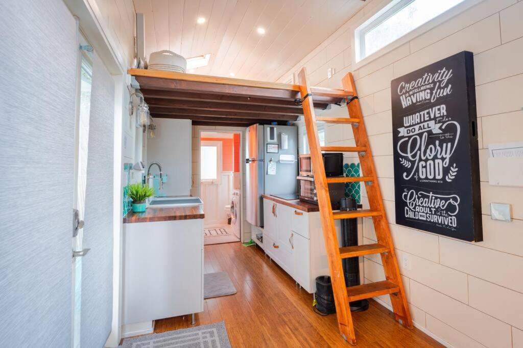 a kitchen with a loft bed in a tiny house at Teal Tiny Home Creek Views in San Luis Obispo