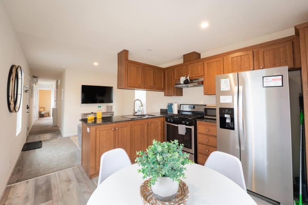 a kitchen with a white table and a refrigerator at 2 Bedroom Coastal Home in SLO in San Luis Obispo