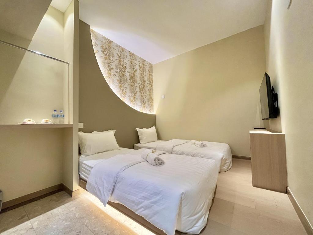 Postel nebo postele na pokoji v ubytování Asimmy Hotel