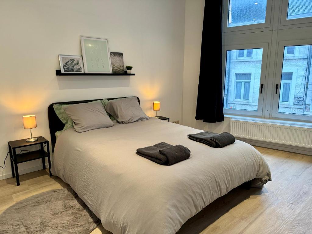 a bedroom with a large bed with two towels on it at Maison en plein centre de Ciney in Ciney