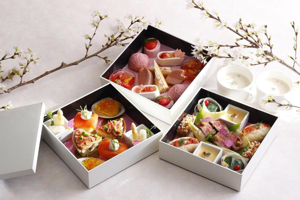 two white boxes filled with different types of food at Tokyo Marriott Hotel in Tokyo