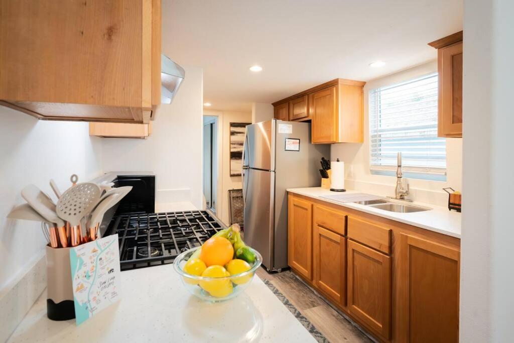 a kitchen with a bowl of fruit on a counter at SLO Oasis Home in San Luis Obispo