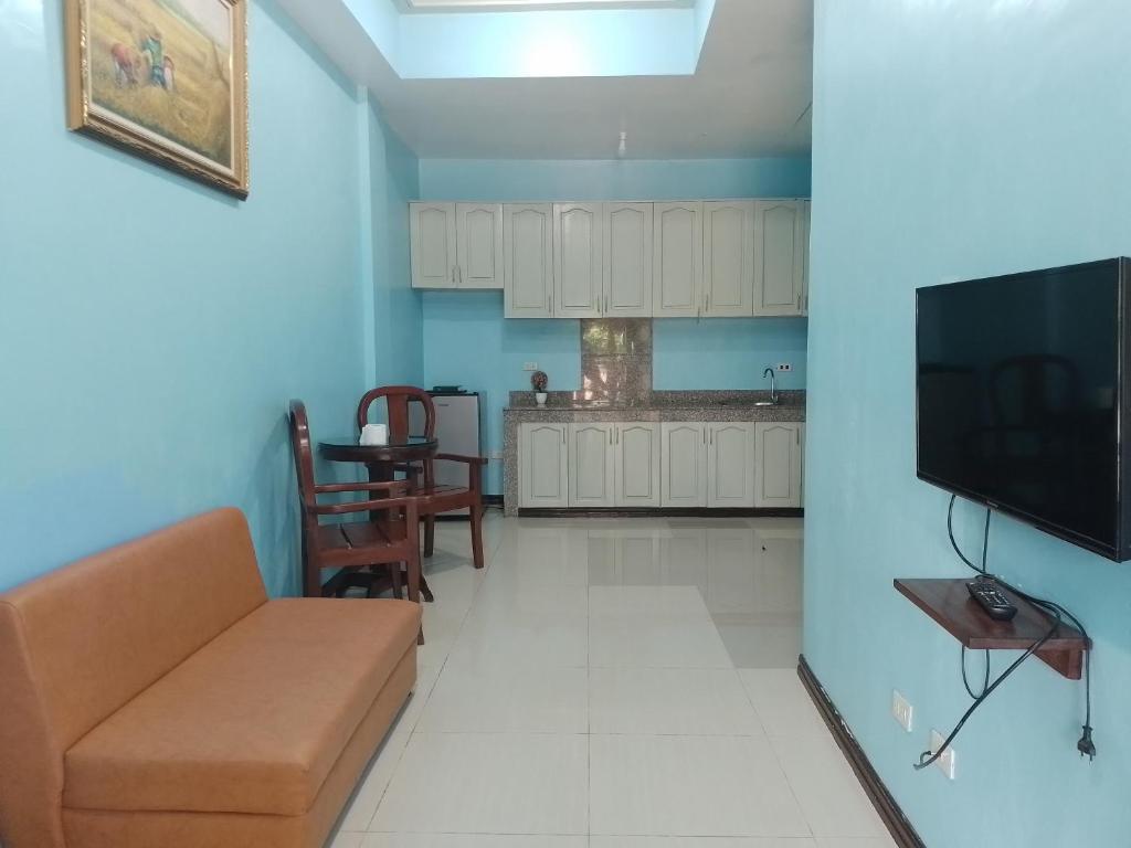 a living room with a couch and a kitchen at Nassim Hotel and Beach Resort in Casagan