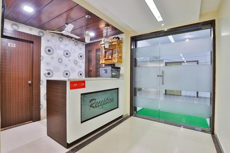 a kitchen with a large glass door in a room at HOTEL KHUSHBOO in Ahmedabad