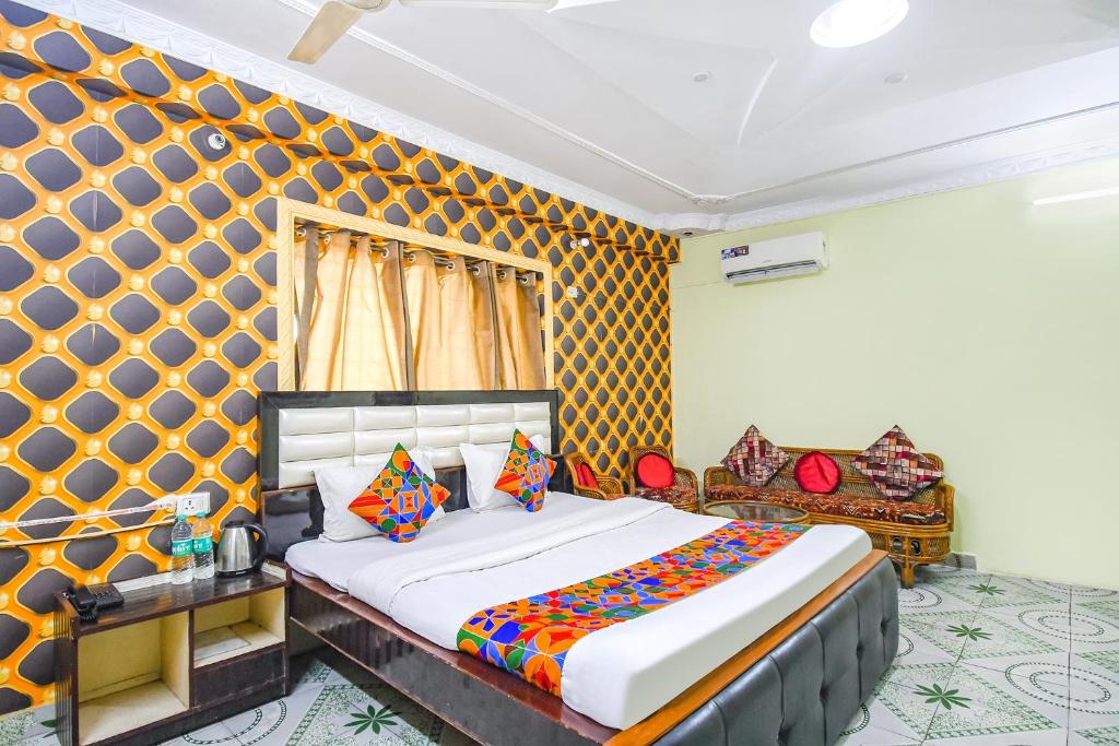 um quarto com uma cama king-size e um sofá em FabHotel Golden Horizon em Ranchi
