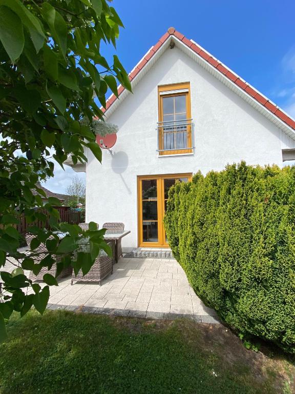 a white house with a bench in front of it at Ferienhaus Steilküste in Fehmarn