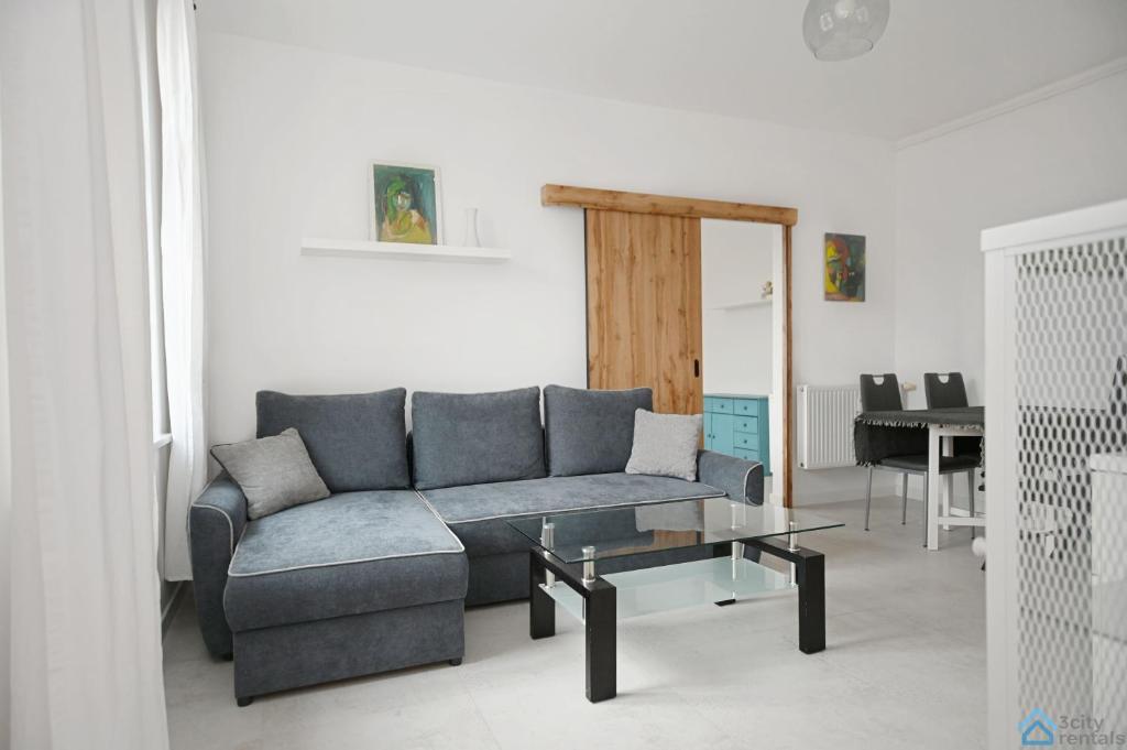 a living room with a couch and a table at Bianco by 3City Rentals in Sopot