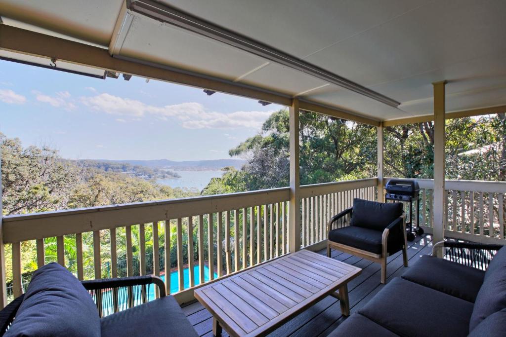 a screened in porch with a couch and a table at Bayview Oasis- With pool in Hardys Bay