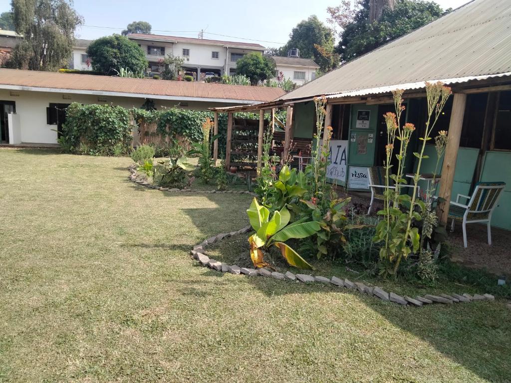 a garden in front of a house with plants at Gaia Eco Hub BnB in Fort Portal