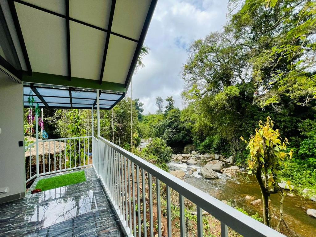 a balcony view of a river from a house at River zone villa in Meppādi