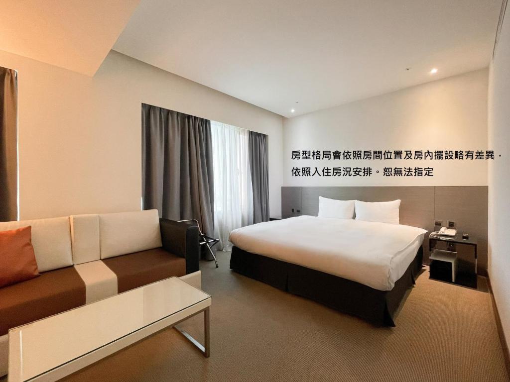 Postel nebo postele na pokoji v ubytování Guide Hotel Hsinchu Zhongyang