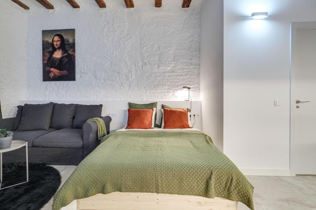 a bedroom with a bed and a couch at Stylish BORN in Barcelona