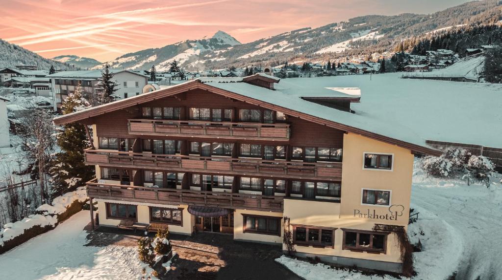 an apartment building with snow on the ground at Parkhotel Kirchberg in Kirchberg in Tirol