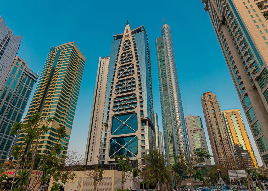 a group of tall buildings in a city at Astonishing 1 Bedroom in Jumeirah Lake Towers in Dubai
