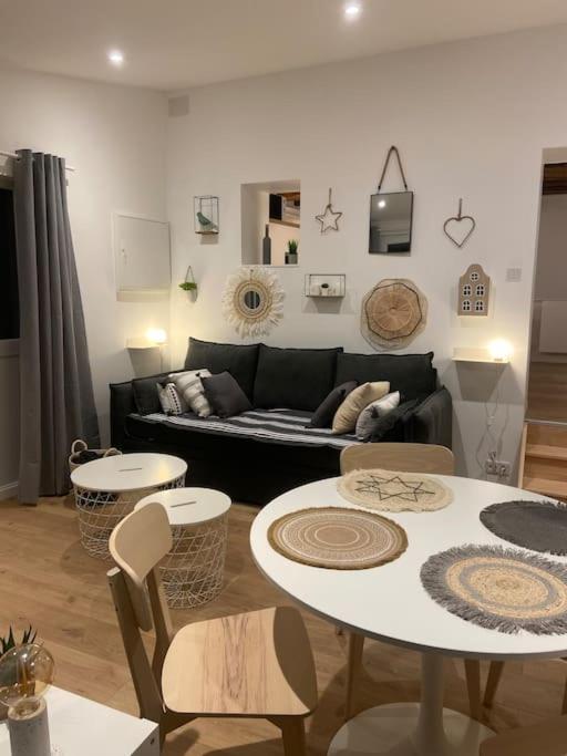 un salon avec un canapé, une table et des chaises dans l'établissement Maisonnette La petite Jeanne, à Boves