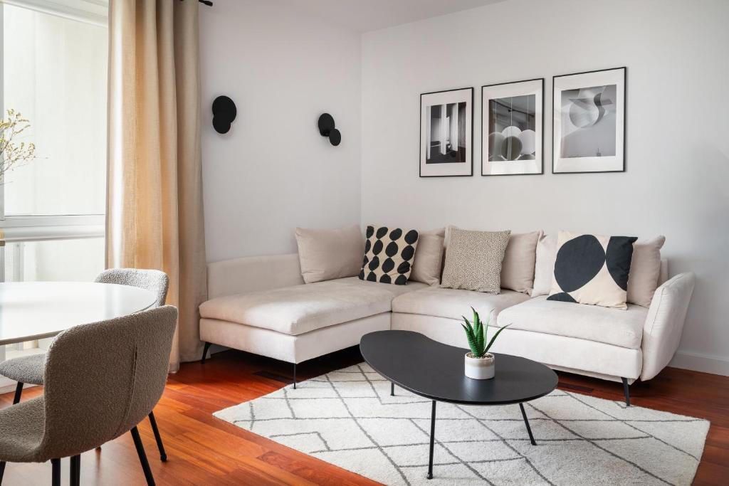 a living room with a couch and a table at Arena Ursynów Luxury Apartment in Warsaw