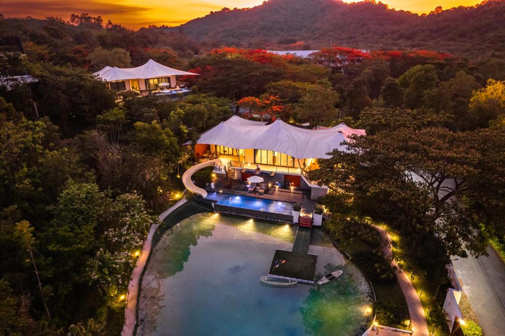 an aerial view of a house with a swimming pool at Te Mata Glamping in Nong Nam Daeng