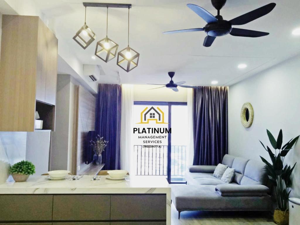 a living room with a couch and a ceiling fan at Executive Escapes [The Netizen Cheras] 3房公寓 #MRT in Cheras