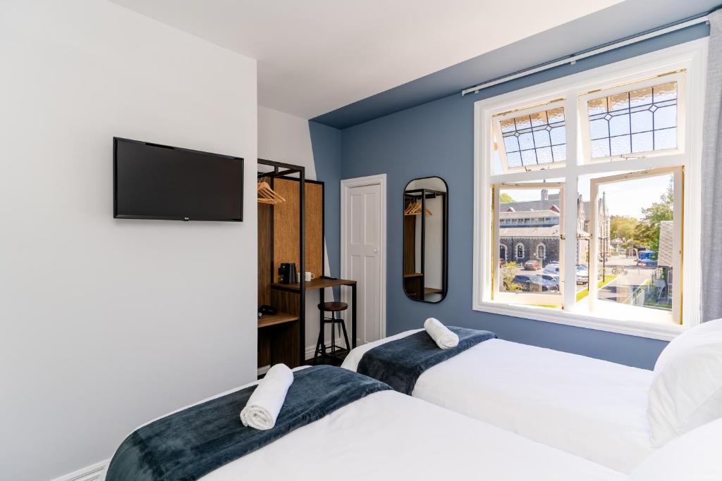 Postel nebo postele na pokoji v ubytování Haka House Christchurch