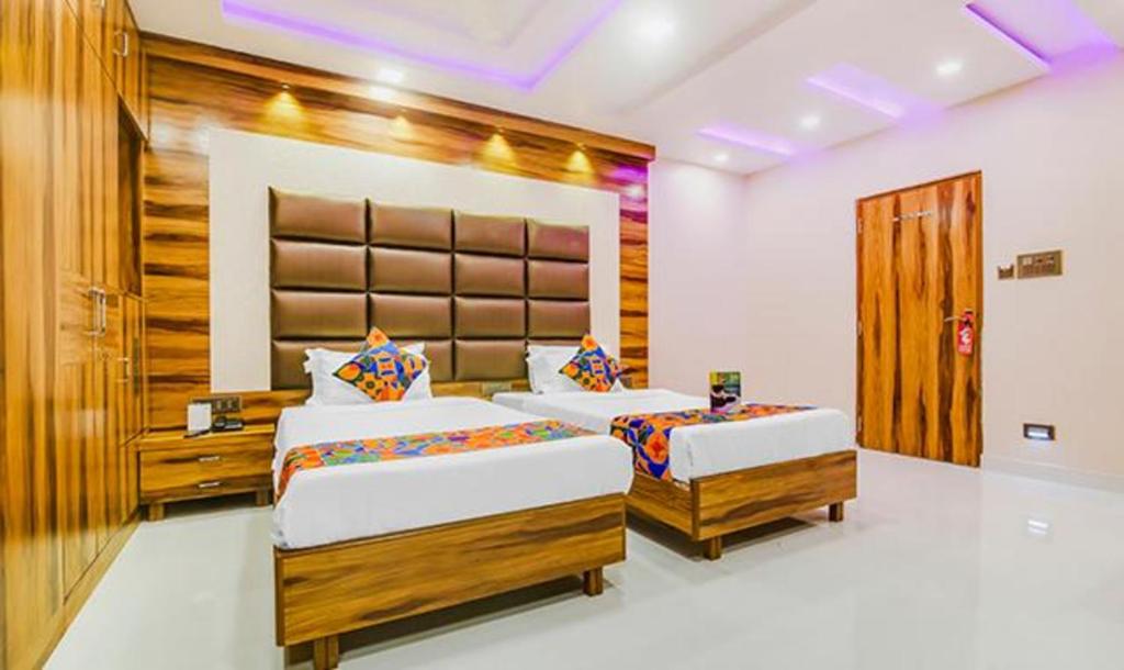 a bedroom with two beds in a room at FabHotel Prime Orion Crystal in Kolkata