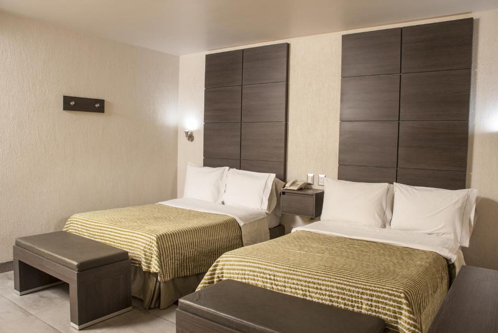 Postel nebo postele na pokoji v ubytování Hotel Expo Abastos