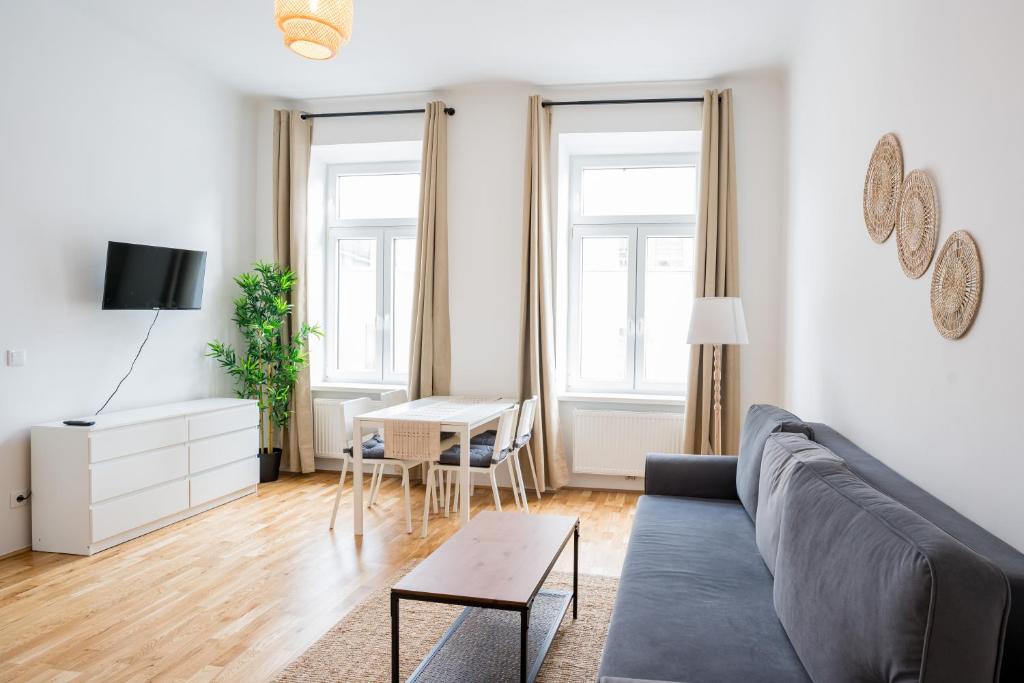 a living room with a couch and a table at Vienna City Apartments 1150 Vienna in Vienna