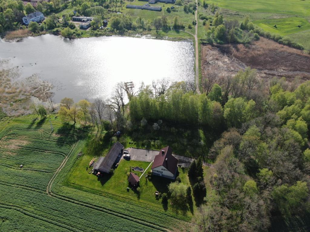 an aerial view of a house next to a lake at Sodyba Žuvalsa 