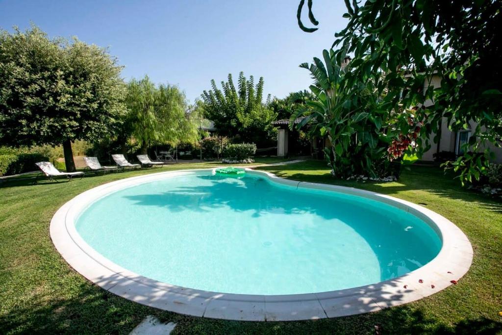 a swimming pool in the yard of a house at Villa Antico Toscano in Polistena