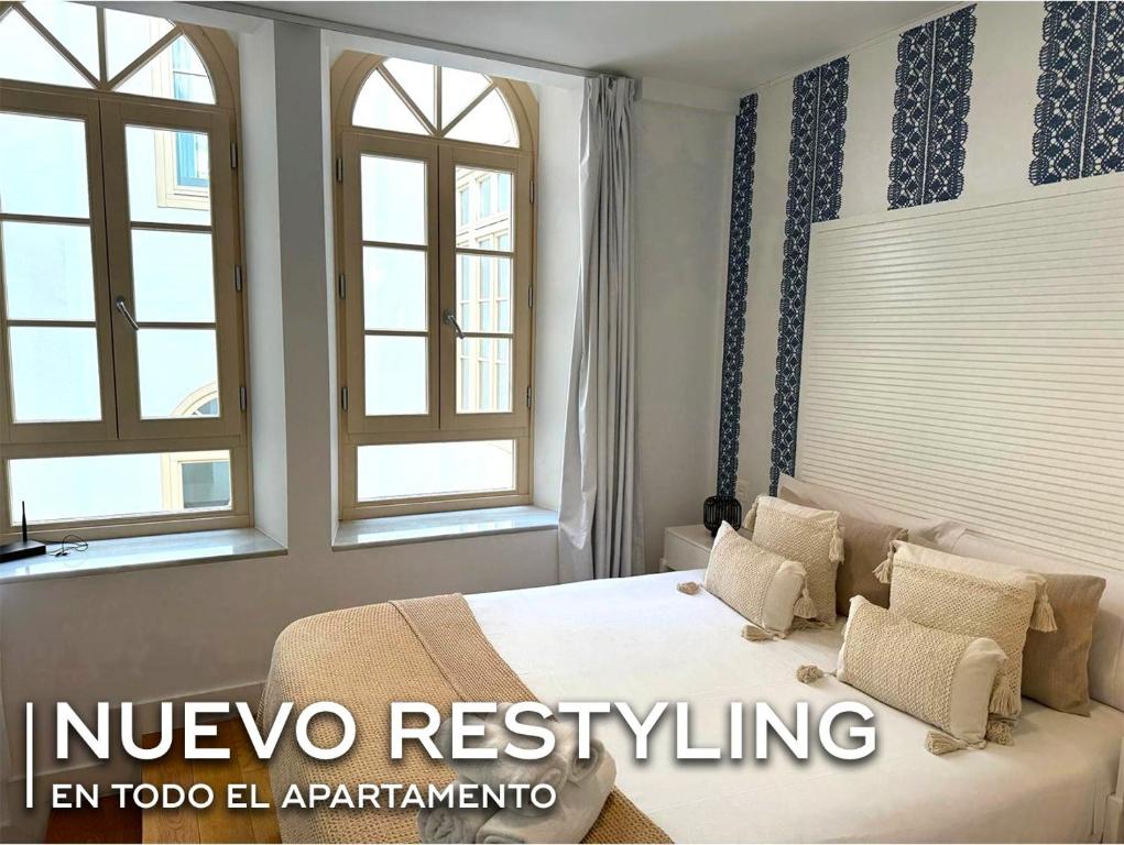 una camera da letto con un letto e due finestre di Echegaray Premium cathedral 1 a Málaga