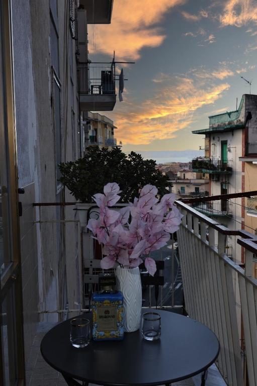a vase of flowers sitting on a table on a balcony at Vesuvio Guest House in Ercolano