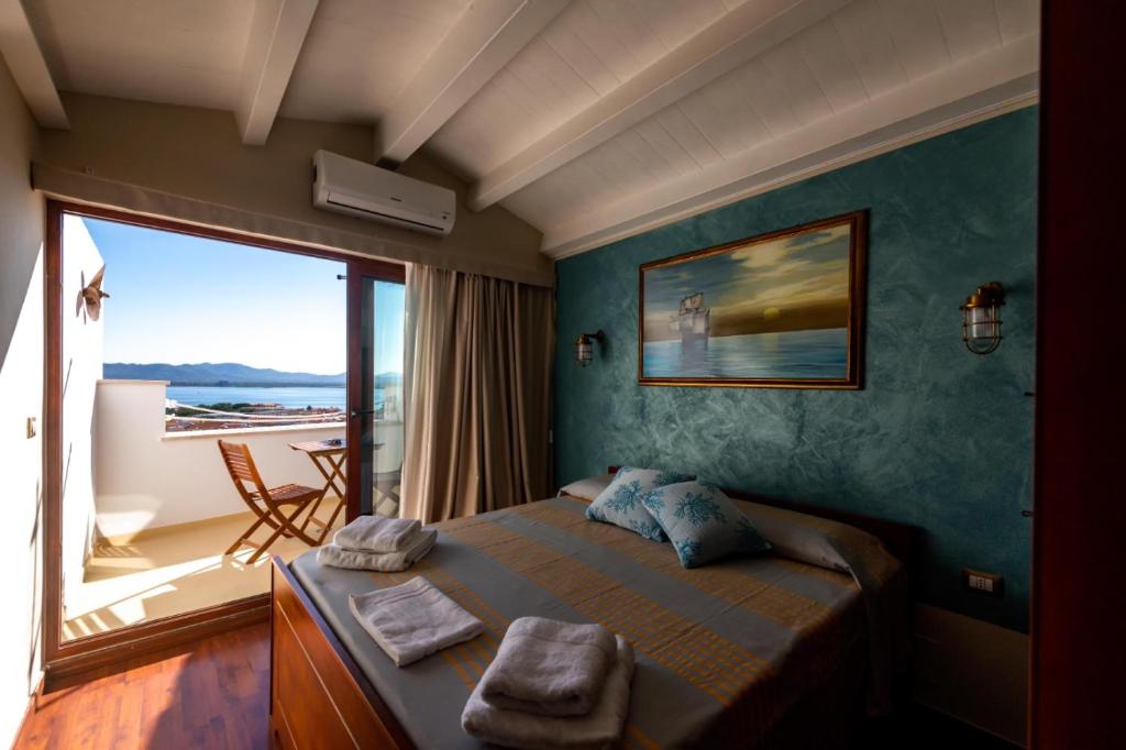 a bedroom with a bed with a view of the ocean at Le Tre Caravelle in SantʼAntìoco