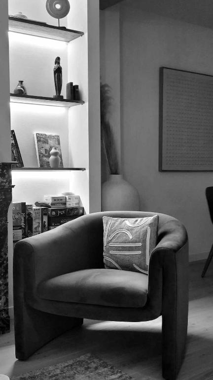 a living room with a couch with a pillow on it at Verdon - Appartement d'Architecte in Comps-sur-Artuby