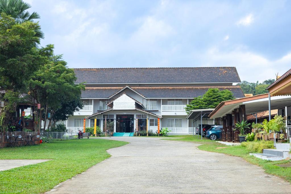 a house with a driveway in front of it at RoomQuest Golden Triangle Premium Collection in Chiang Saen