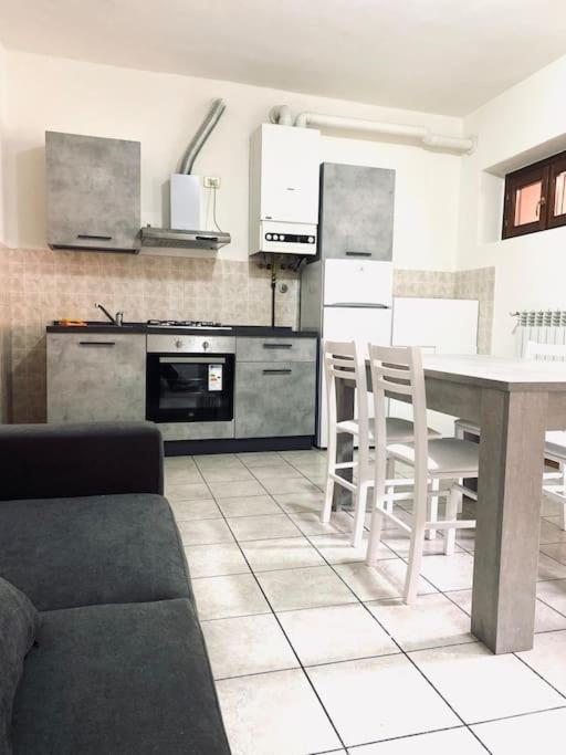 a kitchen with a table and chairs in a room at Casa Milano, Como, Varese in Cislago