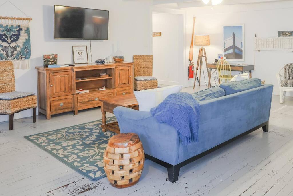 a living room with a blue couch and a table at The Captains Quarters - A Relaxing Nautical Abode in Christiansted