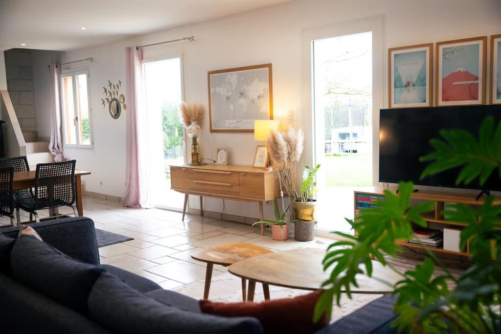 een woonkamer met een bank en een tafel bij Grande Maison Cosy Proche Angers & Bords de Loire in Bouchemaine