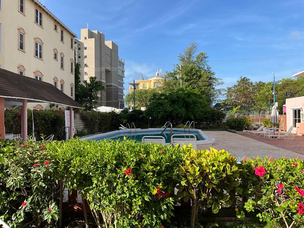a car parked in a parking lot next to a building at The Monteray Hotel in Christ Church