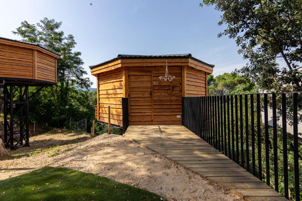 a wooden out house with a wooden walkway at Les Suites in Santa María de Palautordera