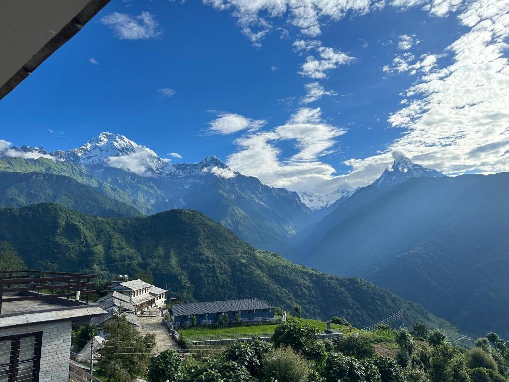 a view of a mountain range with mountains at Hill Top Lodge Ghandruk in Astam