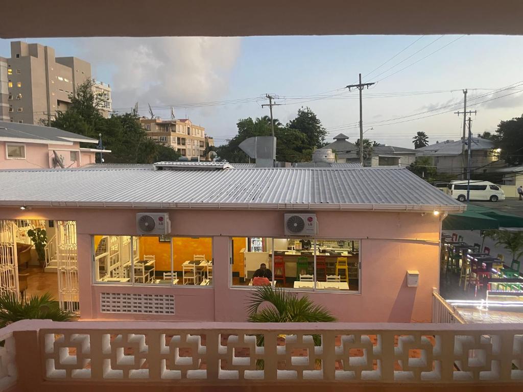 a small house with a roof on a street at The Monteray Hotel in Christ Church