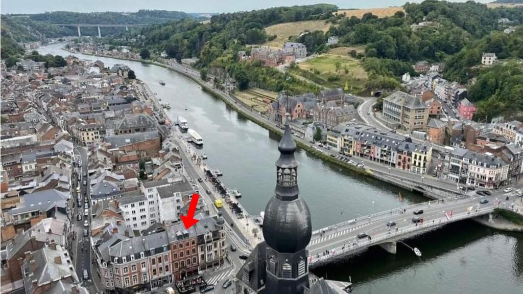 a view of a city with a river and a bridge at NOMAD APARTMENTS - Astrid in Dinant