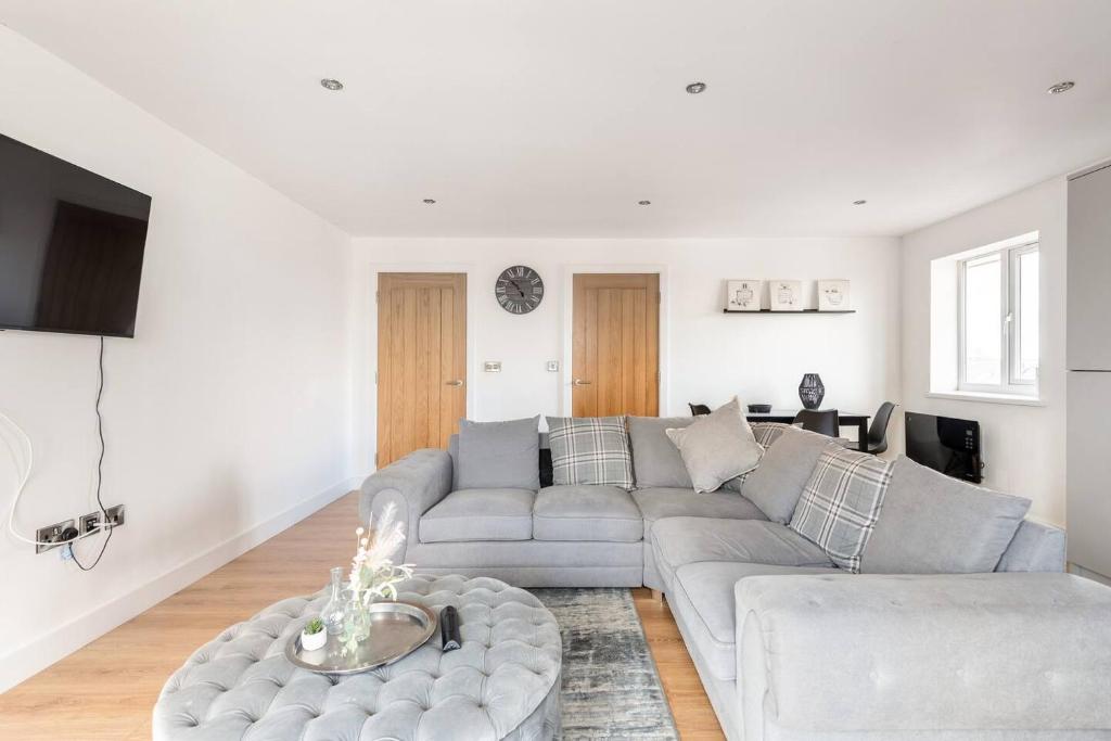 a living room with a couch and a table at Luxurious 3-Bed Penthouse in Sheffield in Handsworth