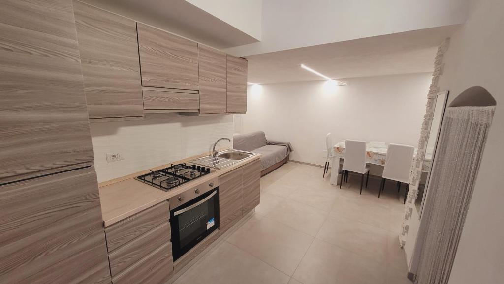 a kitchen with a sink and a stove top oven at Casa Laura in Vieste