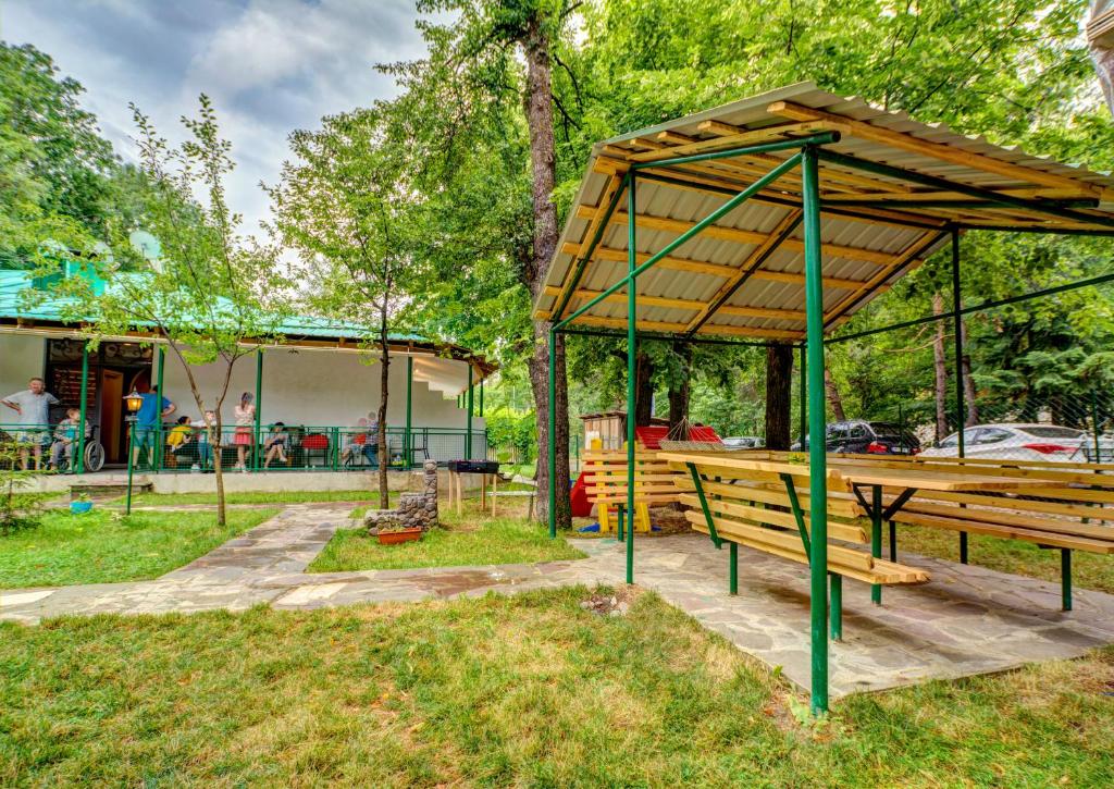 a picnic table and a pavilion in a park at Green Hotel in Abastumani