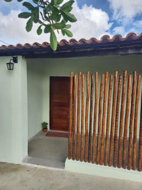 a fence in front of a house with a door at Casa Campo - Domo do Matto in Garanhuns