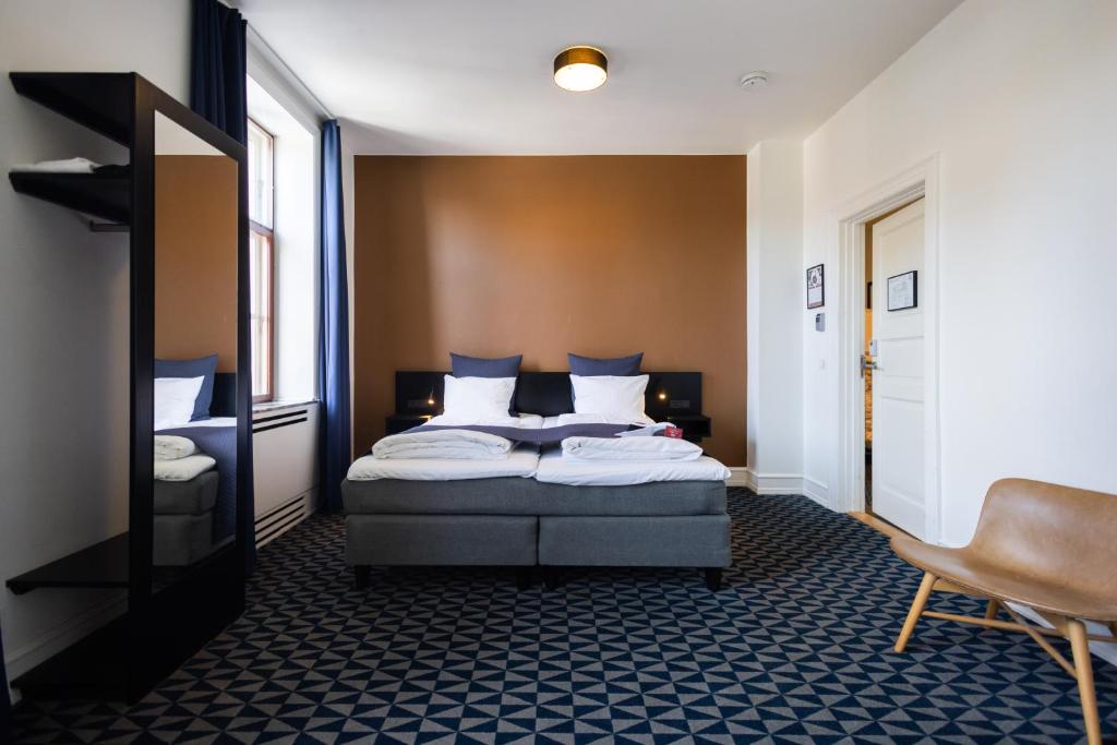 Ένα ή περισσότερα κρεβάτια σε δωμάτιο στο Milling Hotel Ritz Aarhus City