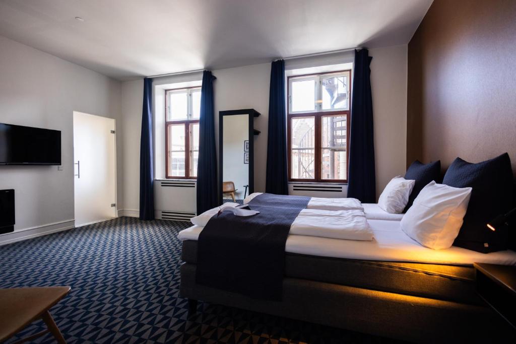 Ένα ή περισσότερα κρεβάτια σε δωμάτιο στο Milling Hotel Ritz Aarhus City