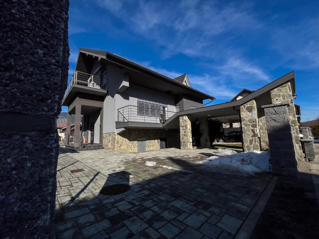 a large white house with a black roof at Apartment Mandy in Rečica ob Savinji